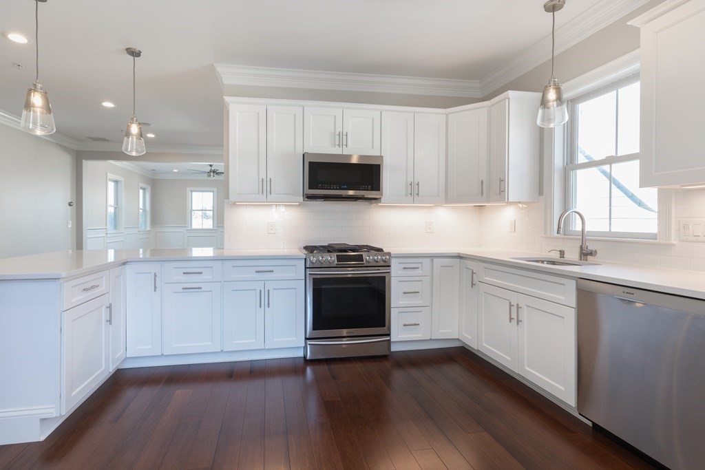 41 Wenham Street, Unit 3 Boston, MA 02130 - Photo 4 of 13 a kitchen with granite countertop white cabinets and white appliances