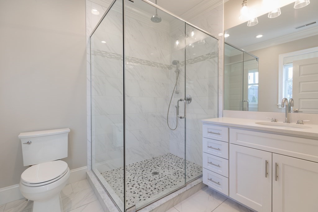 41 Wenham Street, Unit 3 Boston, MA 02130 - Photo 6 of 13 a bathroom with a shower sink mirror and toilet