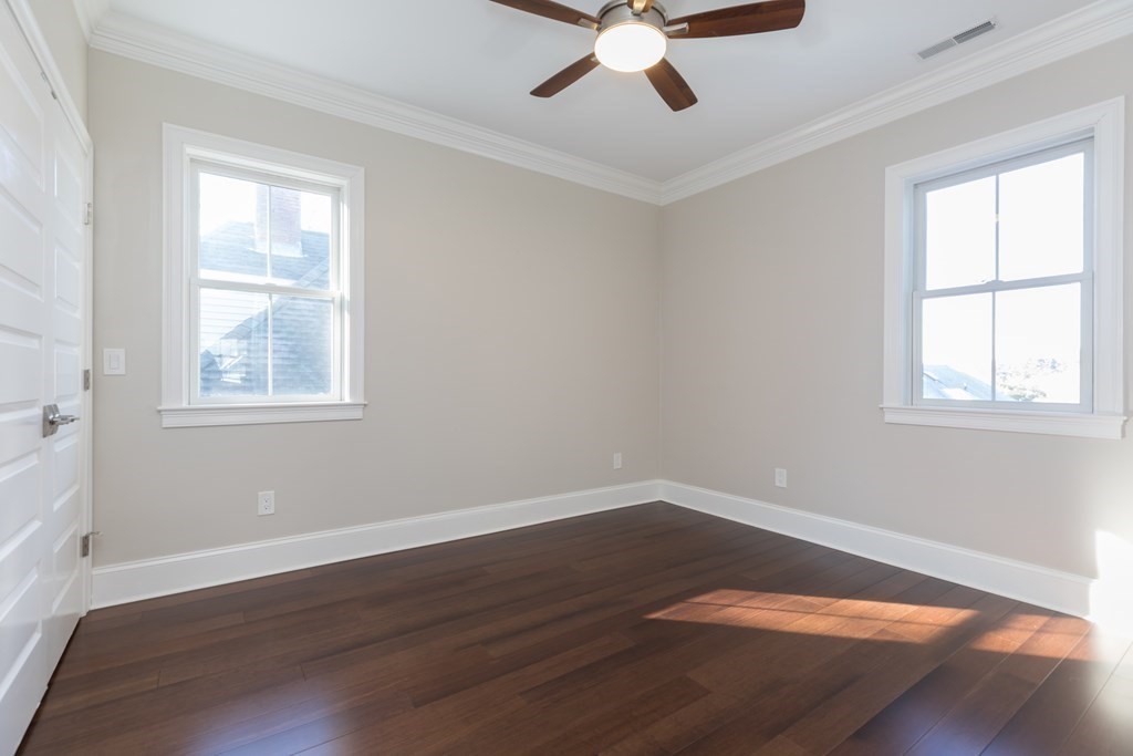 41 Wenham Street, Unit 3 Boston, MA 02130 - Photo 8 of 13 a view of a big room with wooden floor and windows