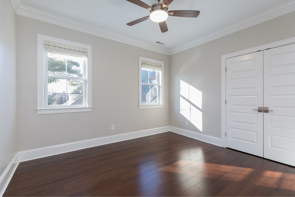 41 Wenham Street, Unit 3 Boston, MA 02130 - Photo 9 of 13 a view of an empty room with wooden floor and window