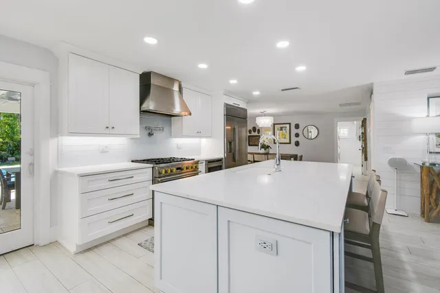 a kitchen with a sink stainless steel appliances and cabinets