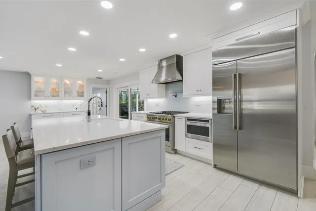 a spacious bedroom with a bed and a large window with outer view