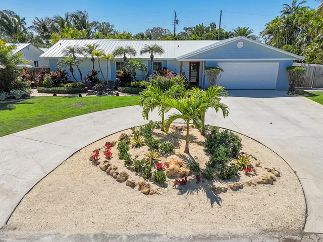 a view of a house with a yard and a garden