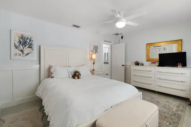 a bathroom with a granite countertop toilet sink and mirror