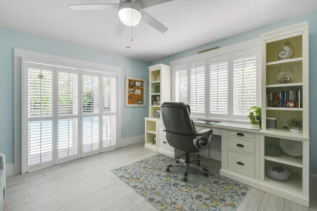 a living room with furniture a flat screen tv and a large window