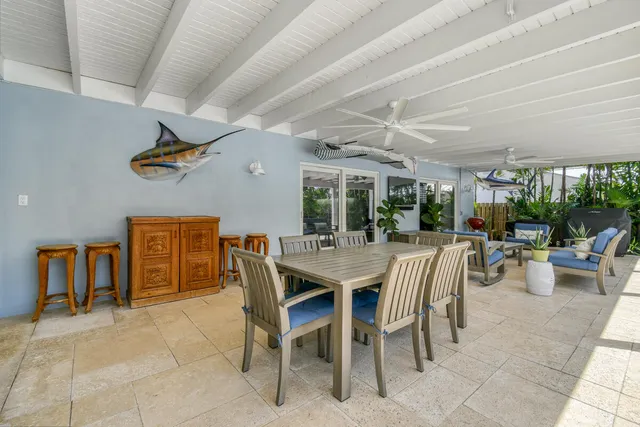 a view of a patio with a table and chairs under an umbrella