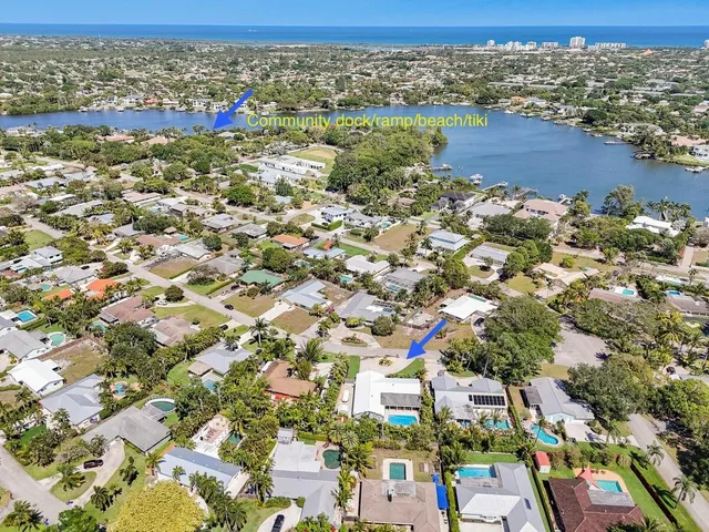 an aerial view of a residential houses with outdoor space and city view