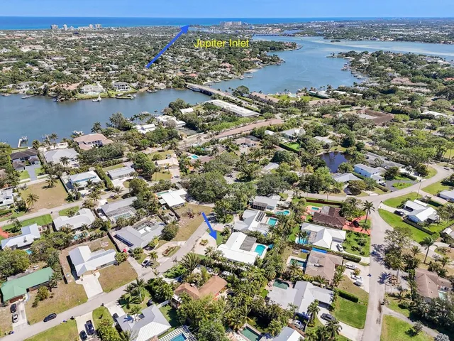 an aerial view of a house with a yard and garden