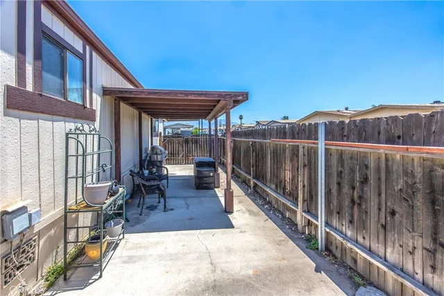 a backyard of a house with table and chairs