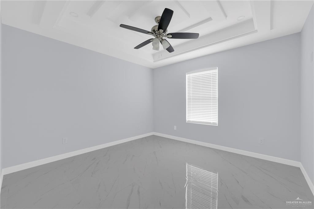 1620 Shadow Creek Drive, Unit 1 Weslaco, TX 78596 - Photo 9 of 11 an empty room with a window and a fan