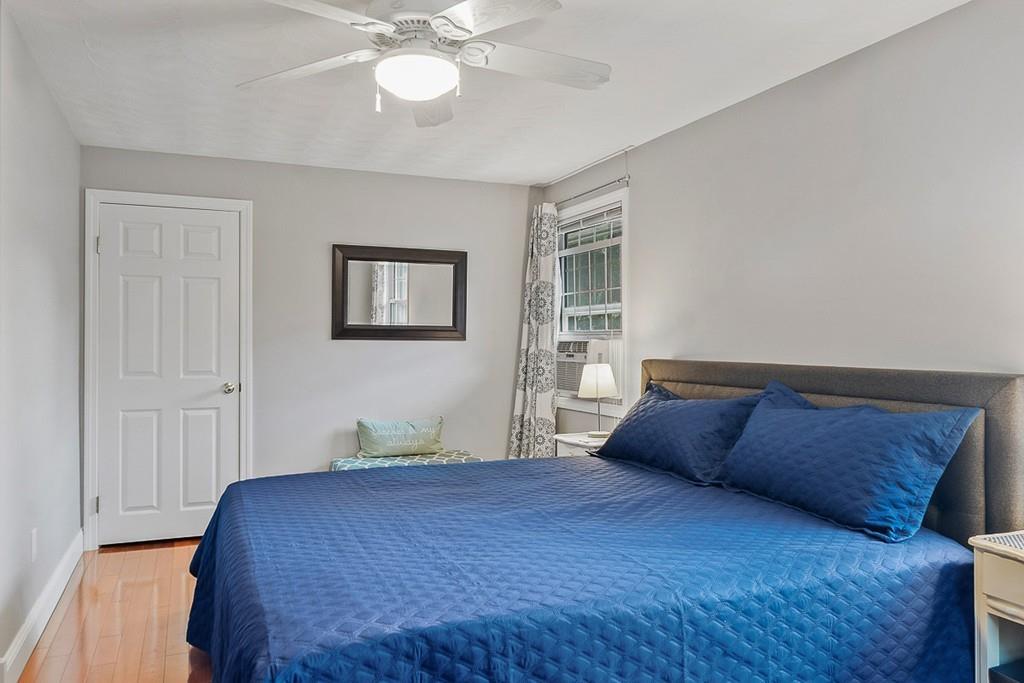 10 Craig Road Chelmsford, MA 01824 - Photo 19 of 34 a bedroom with a large bed and a chandelier
