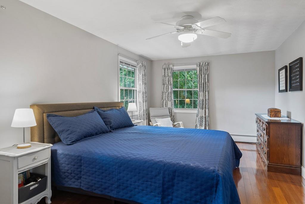 10 Craig Road Chelmsford, MA 01824 - Photo 20 of 34 a bedroom with a large bed a chandelier and a window