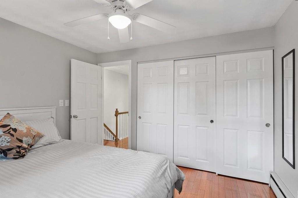 10 Craig Road Chelmsford, MA 01824 - Photo 25 of 34 a bedroom with a bed and a chandelier
