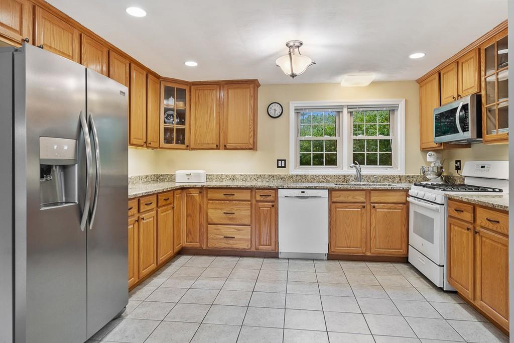 10 Craig Road Chelmsford, MA 01824 - Photo 8 of 34 a large kitchen with stainless steel appliances granite countertop a refrigerator and a sink