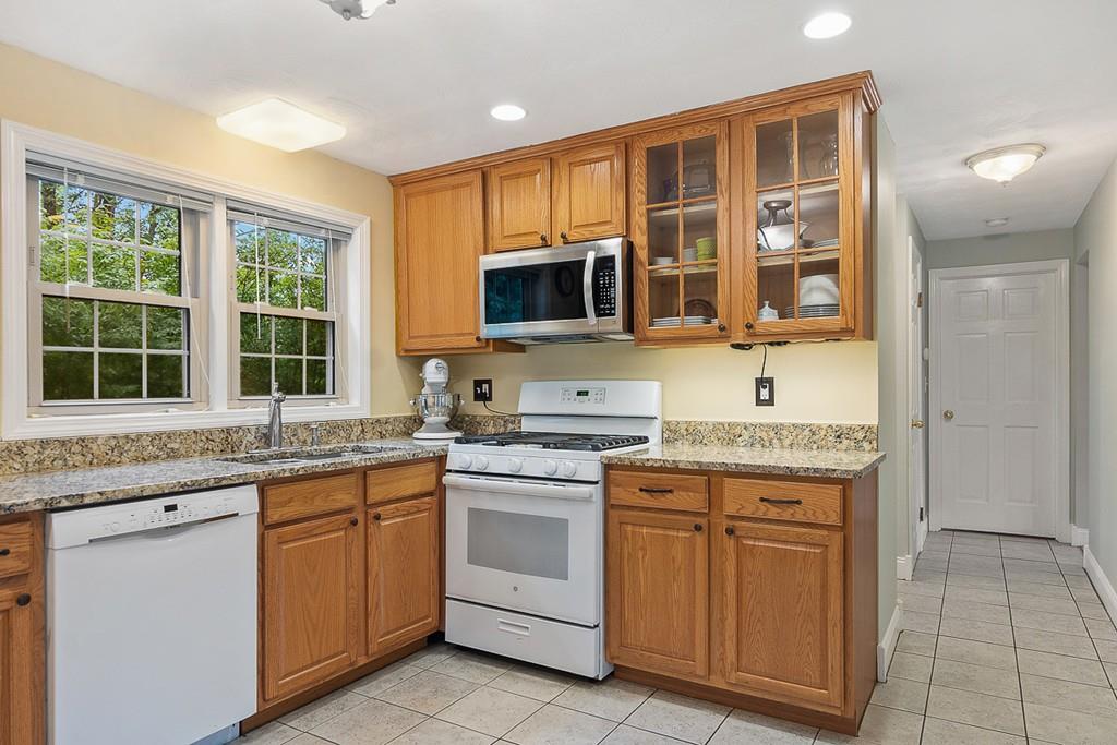 10 Craig Road Chelmsford, MA 01824 - Photo 9 of 34 a kitchen with granite countertop a sink stove and cabinets
