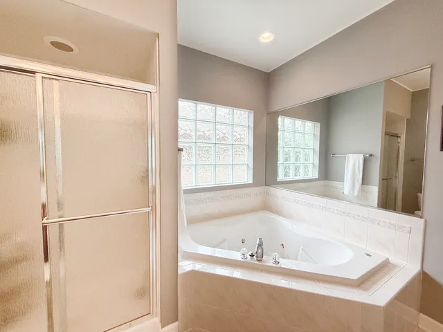 a bathroom with a bathtub and a shower