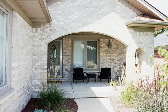 a front view of a house with outdoor seating