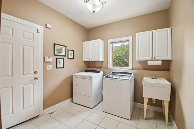 a utility room with closet dryer and washer