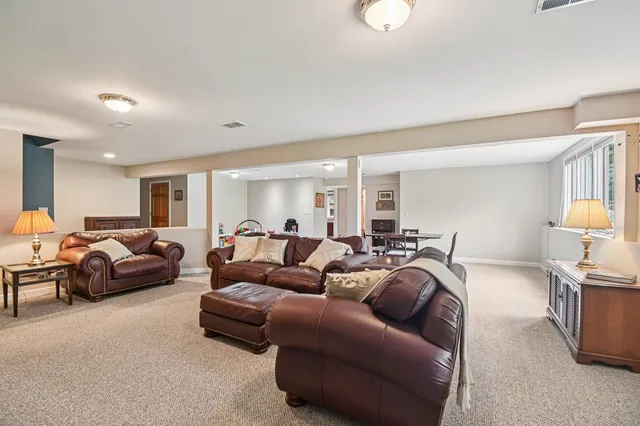 a living room with furniture a flat screen tv and a window