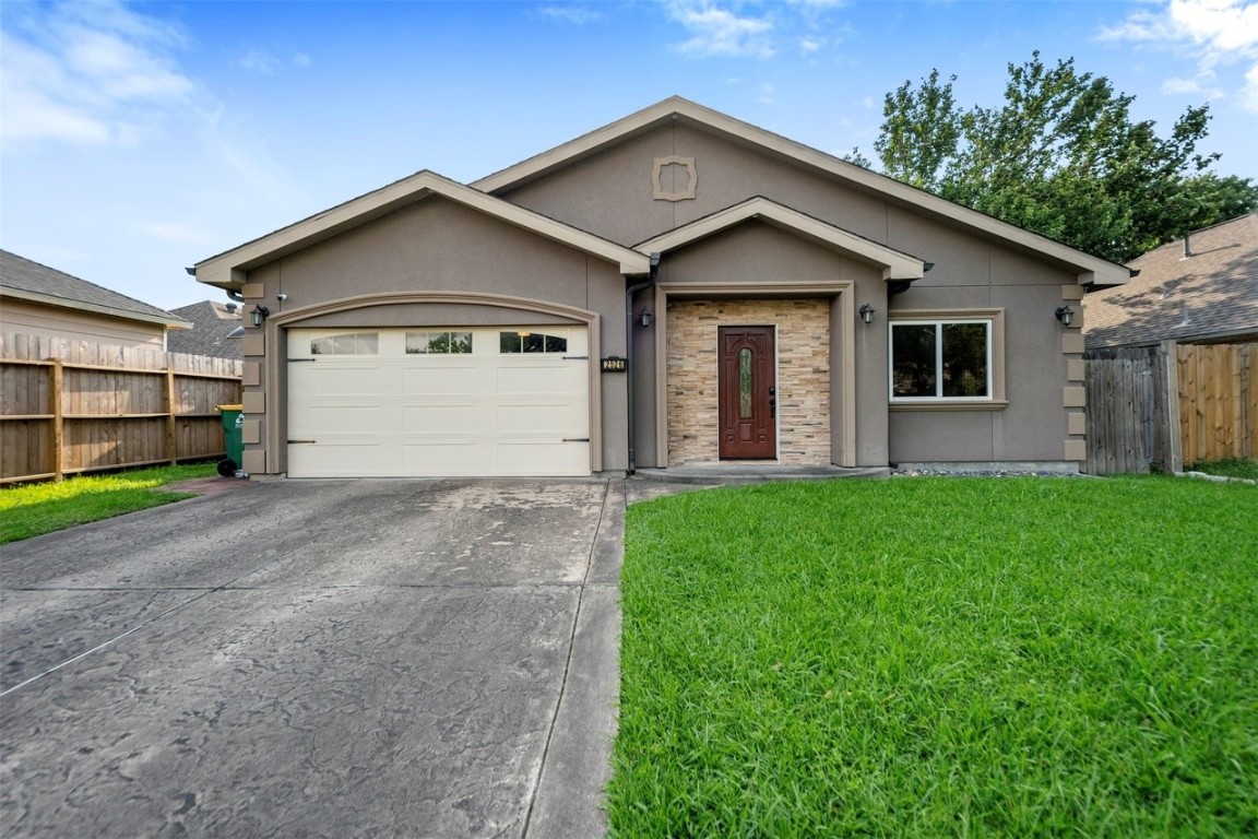 a view of a house with a yard and garage