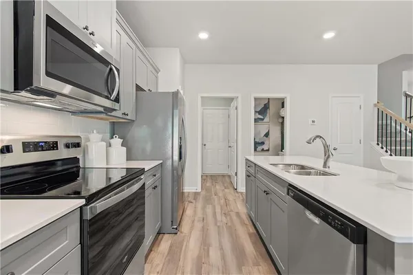 a kitchen with stainless steel appliances granite countertop a sink stove and refrigerator