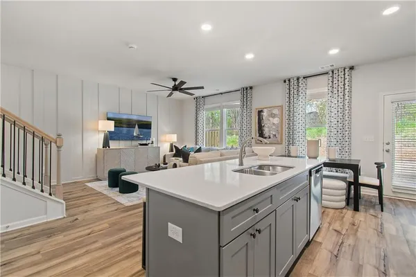 a kitchen with sink stove and refrigerator