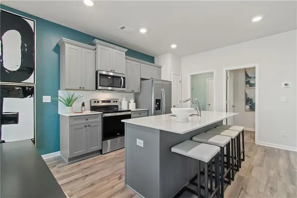 a kitchen with a sink stove and refrigerator