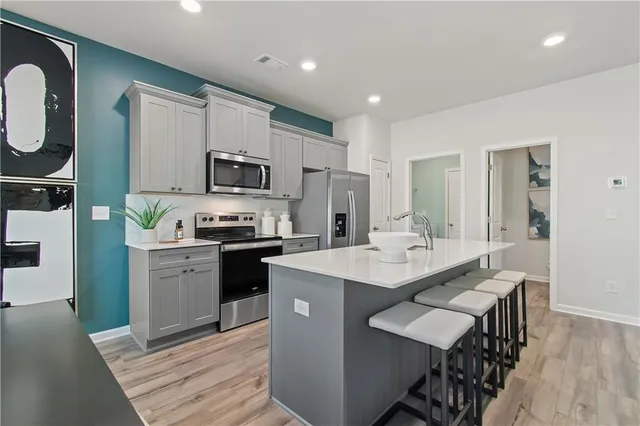 a kitchen with a sink stove and refrigerator