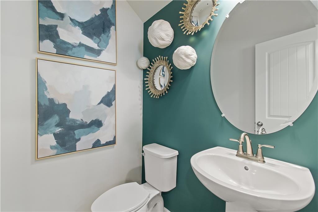 109 Zircon Lane Stockbridge, GA 30281 - Photo 17 of 32 a bathroom with a toilet a sink and mirror