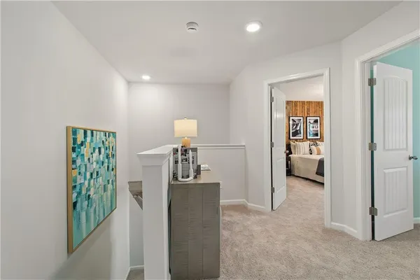 a view of hallway with livingroom and stairs