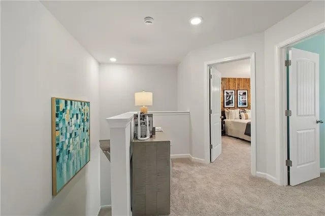 a view of hallway with livingroom and stairs