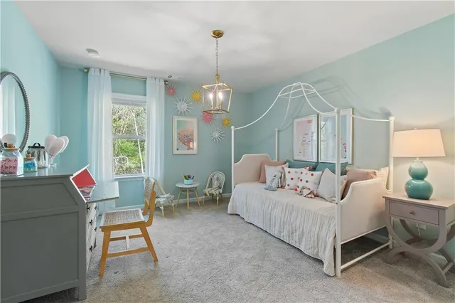 a living room with furniture a table and a chandelier