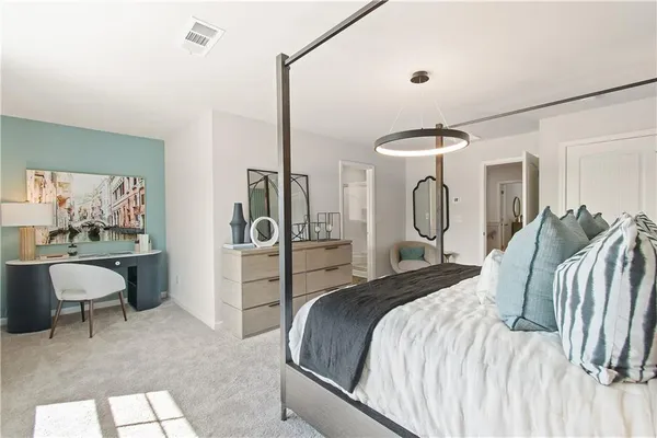a bedroom with a bed and a chandelier