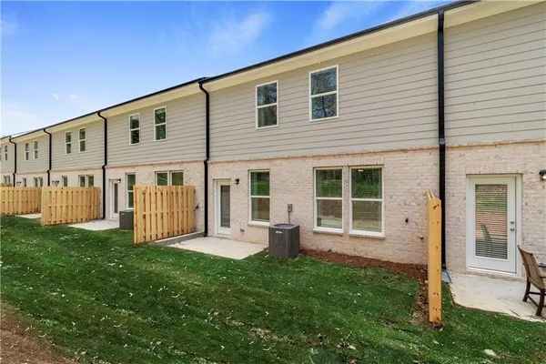 a view of a house with a yard and porch