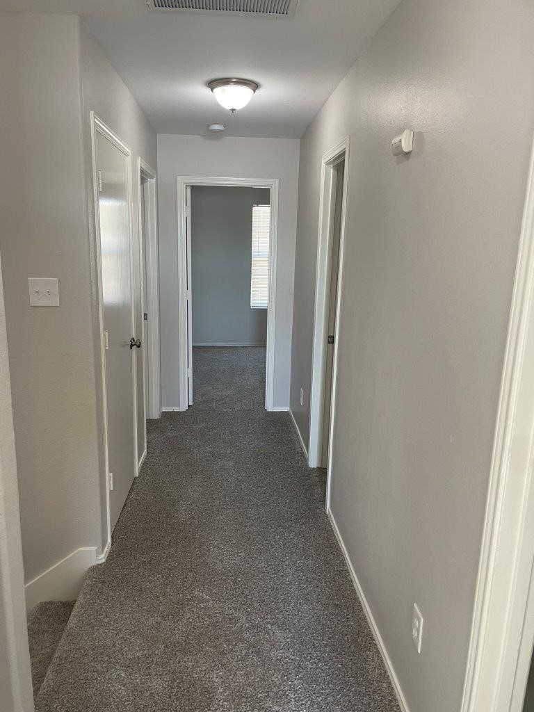 12704 Rio Nueces Lane Rosharon, TX 77583 - Photo 29 of 41 a view of a hallway with wooden shelves