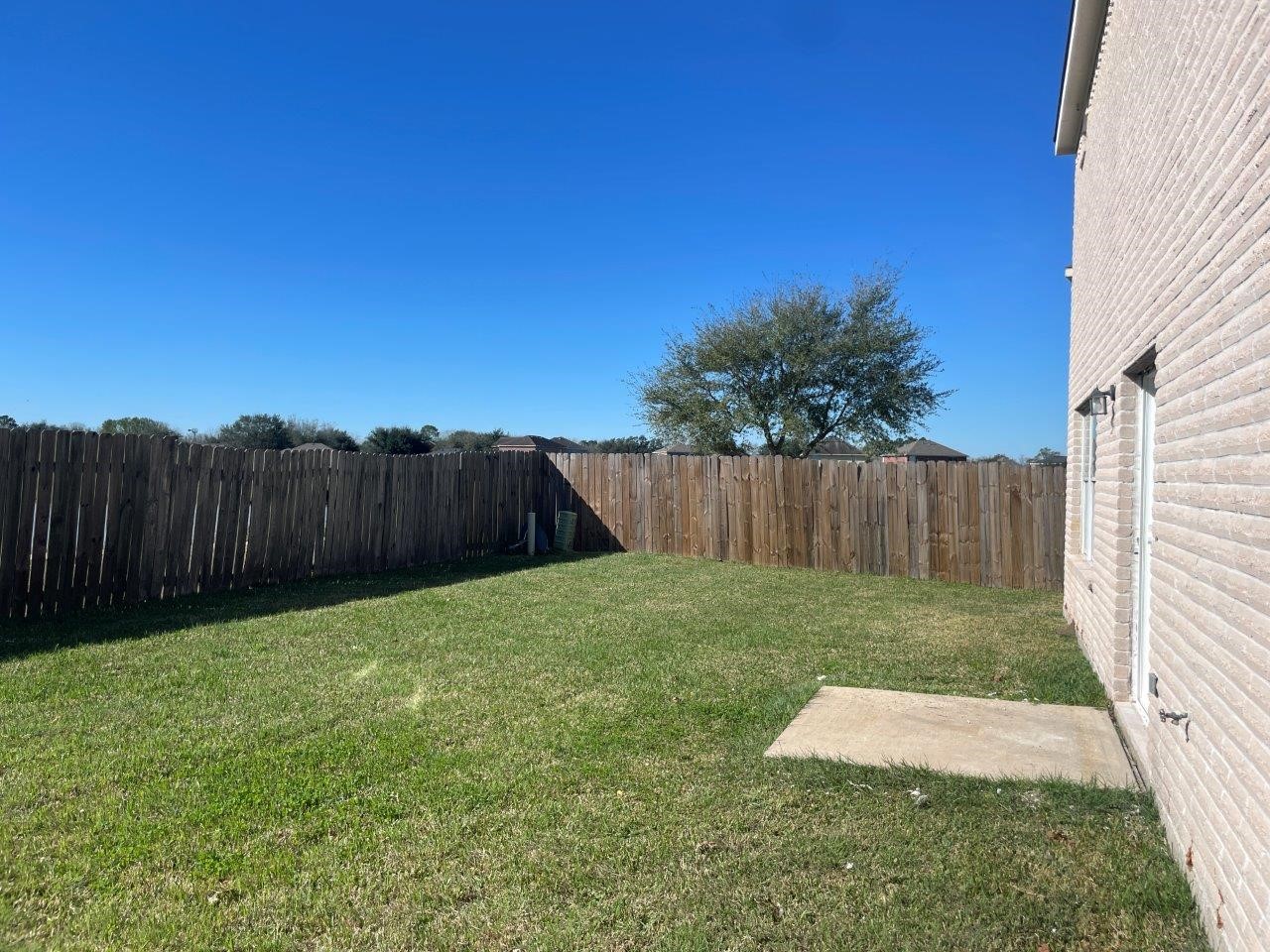 12704 Rio Nueces Lane Rosharon, TX 77583 - Photo 40 of 41 a view of a backyard with wooden fence