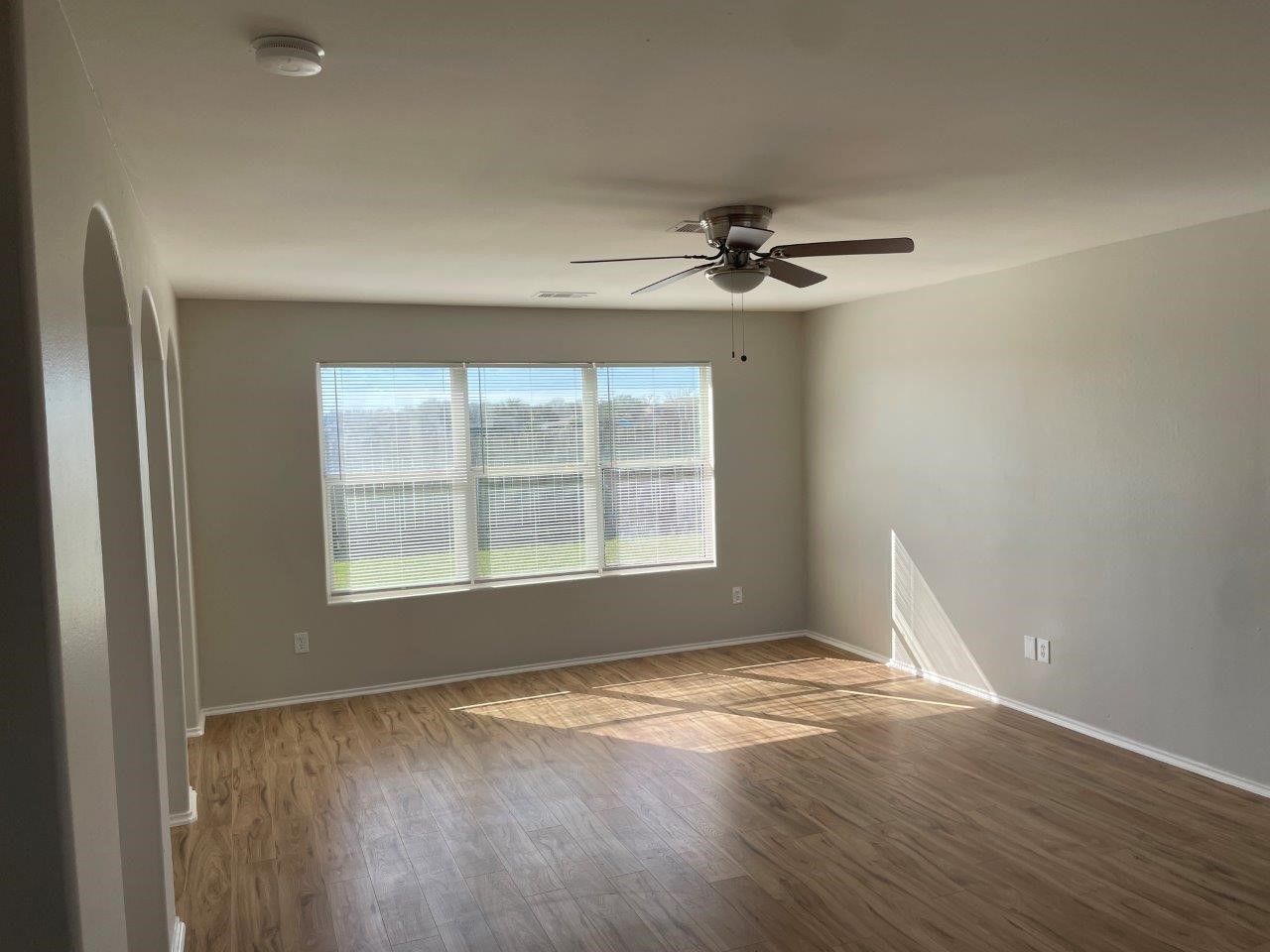 12704 Rio Nueces Lane Rosharon, TX 77583 - Photo 4 of 41 an empty room with wooden floor and windows