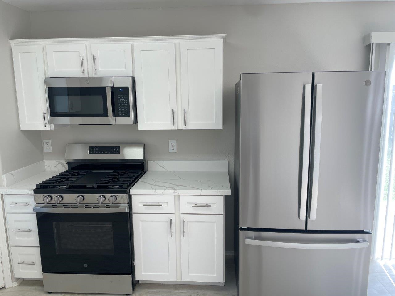 12704 Rio Nueces Lane Rosharon, TX 77583 - Photo 7 of 41 a kitchen with cabinets and stainless steel appliances