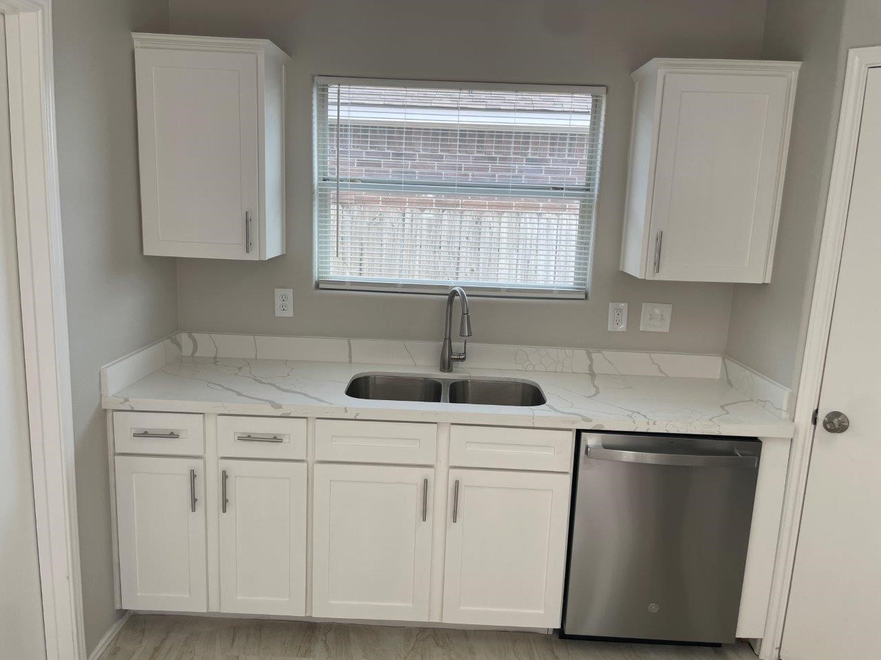 12704 Rio Nueces Lane Rosharon, TX 77583 - Photo 9 of 41 a kitchen with white cabinets and sink