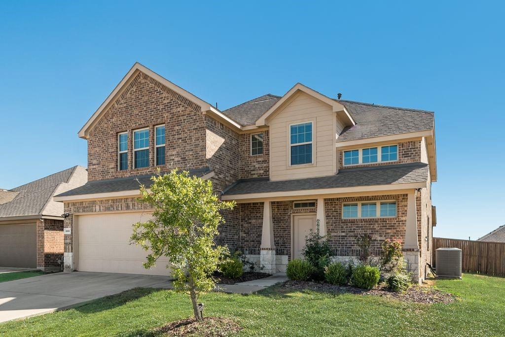 633 Bassett Hall Road Fate, TX 75189 - Photo 1 of 20 a front view of a house with a yard and garage