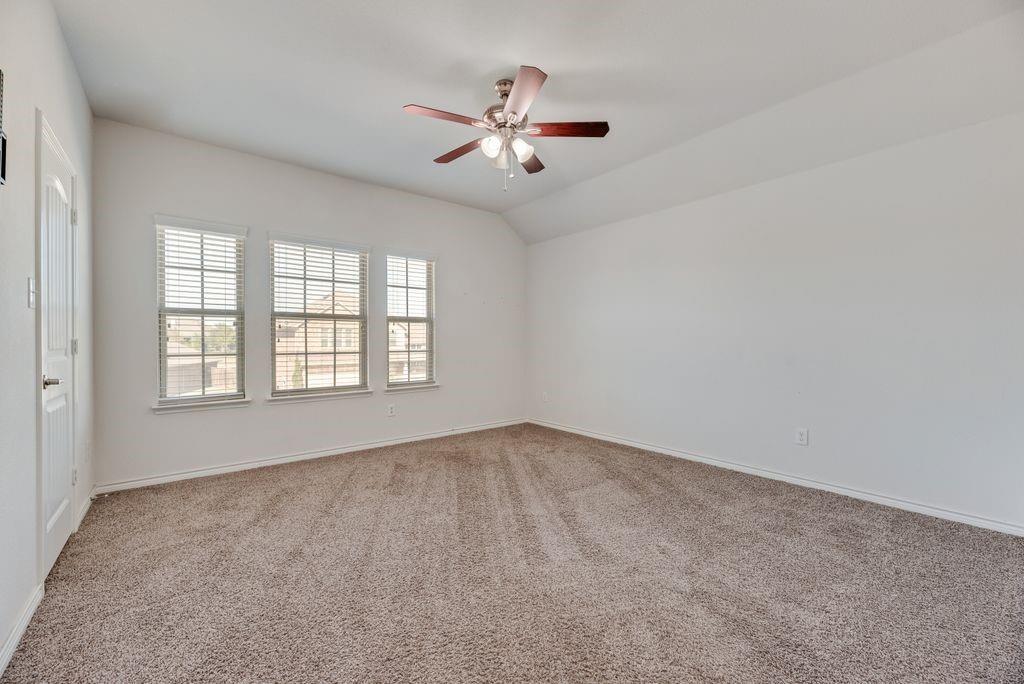 633 Bassett Hall Road Fate, TX 75189 - Photo 10 of 20 an empty room with windows and ceiling fan