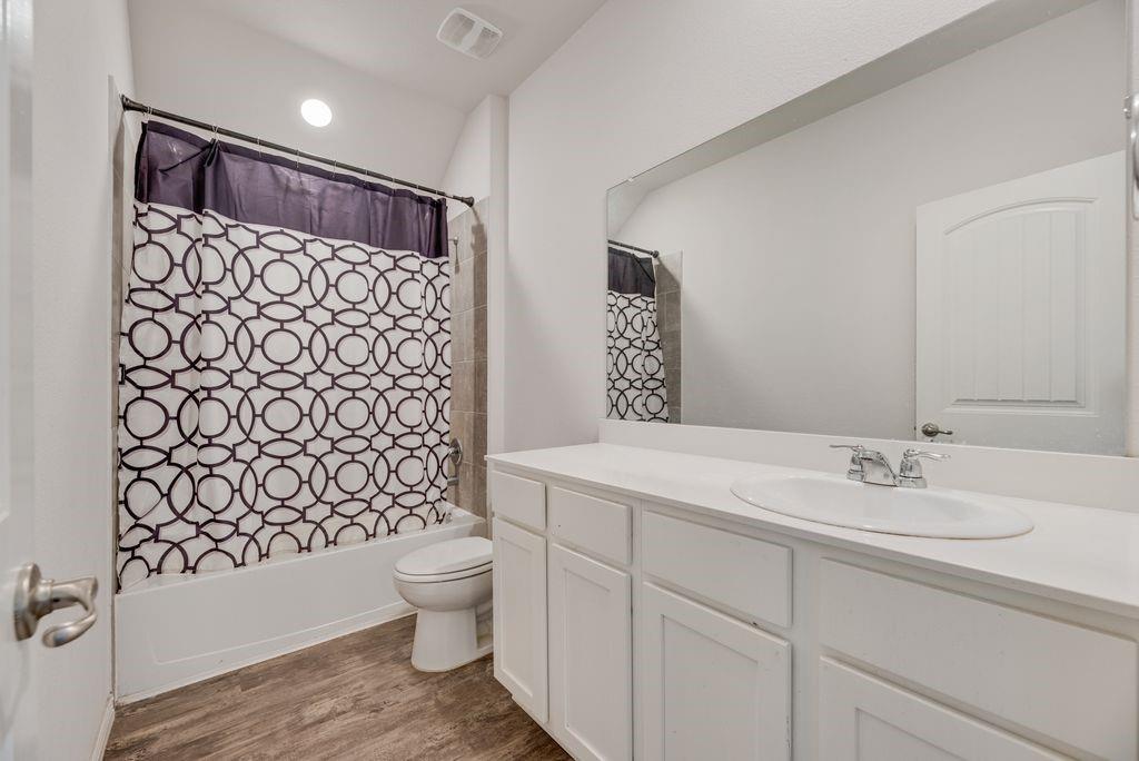 633 Bassett Hall Road Fate, TX 75189 - Photo 11 of 20 a bathroom with a sink toilet and shower