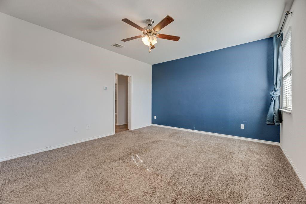 633 Bassett Hall Road Fate, TX 75189 - Photo 14 of 20 a view of an empty room with a ceiling fan and window