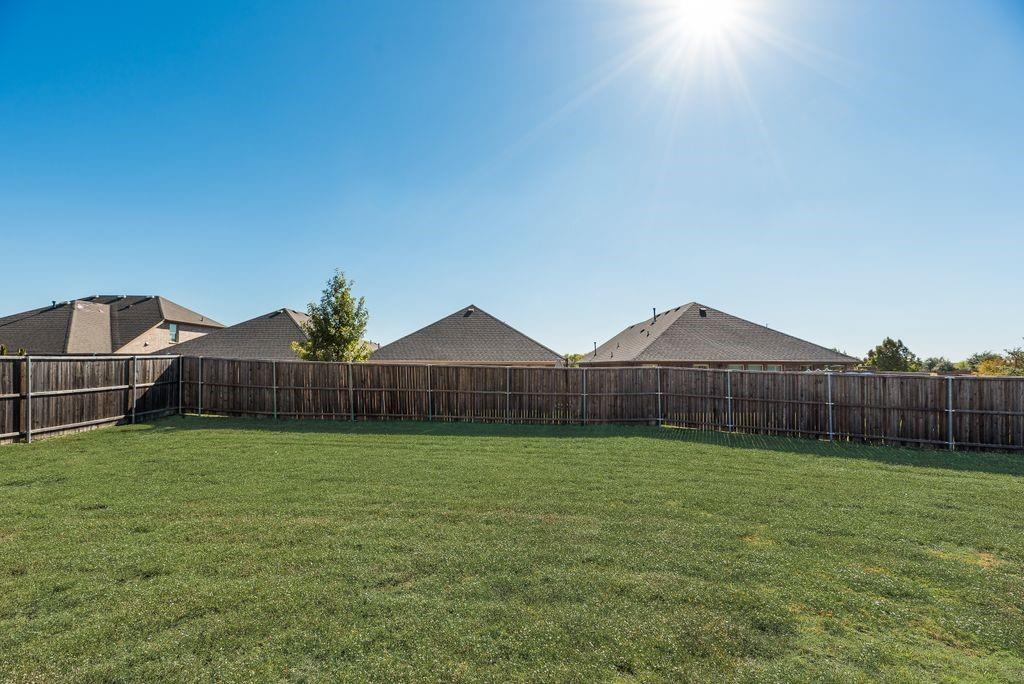 633 Bassett Hall Road Fate, TX 75189 - Photo 18 of 20 a large yard with wooden fence
