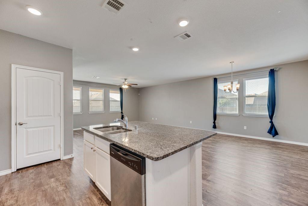 633 Bassett Hall Road Fate, TX 75189 - Photo 20 of 20 an empty room with wooden floor and windows
