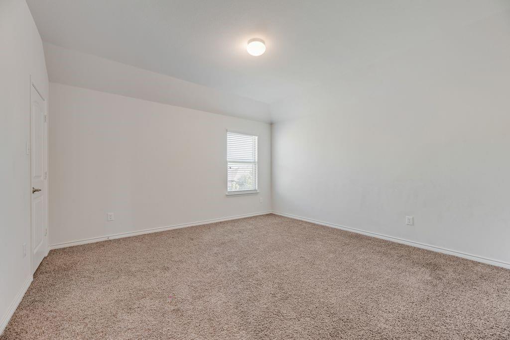 633 Bassett Hall Road Fate, TX 75189 - Photo 8 of 20 an empty room with a empty space and windows