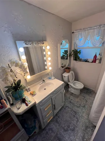 a spacious bathroom with sink and mirror