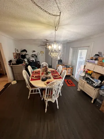 a dining room with furniture and chandelier kitchen view