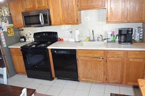 12 Summer Street Wareham, MA 02571 - Photo 21 of 24 a kitchen with stainless steel appliances granite countertop a stove a microwave and a refrigerator
