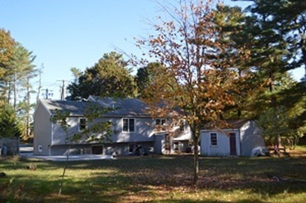 12 Summer Street Wareham, MA 02571 - Photo 6 of 24 a front view of a house with a garden and trees